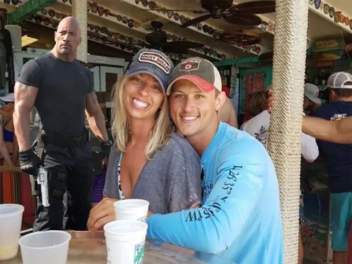 Couple Asks Internet To Photoshop Out Shirtless Guy From Engagement Photo, Regrets It Immediately