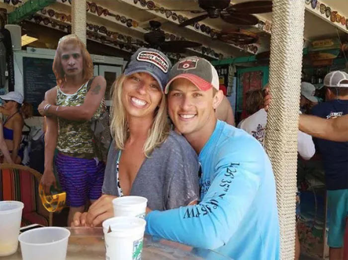 Couple Asks Internet To Photoshop Out Shirtless Guy From Engagement Photo, Regrets It Immediately
