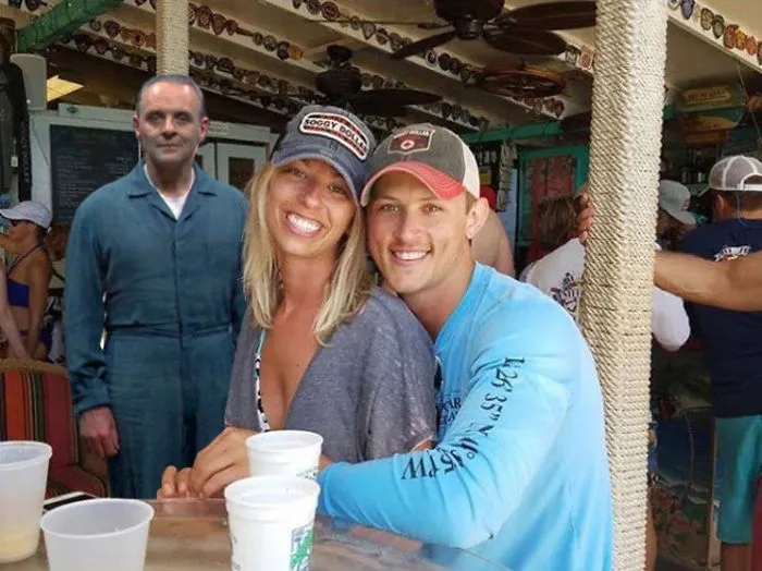 Couple Asks Internet To Photoshop Out Shirtless Guy From Engagement Photo, Regrets It Immediately
