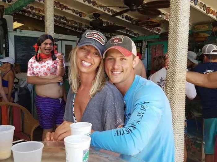 Couple Asks Internet To Photoshop Out Shirtless Guy From Engagement Photo, Regrets It Immediately