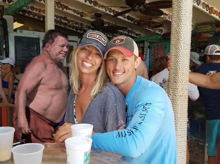 Couple Asks Internet To Photoshop Out Shirtless Guy From Engagement Photo, Regrets It Immediately
