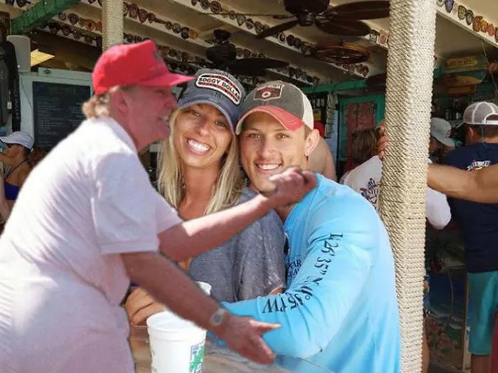 Couple Asks Internet To Photoshop Out Shirtless Guy From Engagement Photo, Regrets It Immediately
