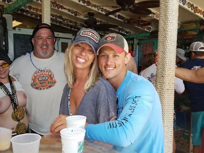 Couple Asks Internet To Photoshop Out Shirtless Guy From Engagement Photo, Regrets It Immediately