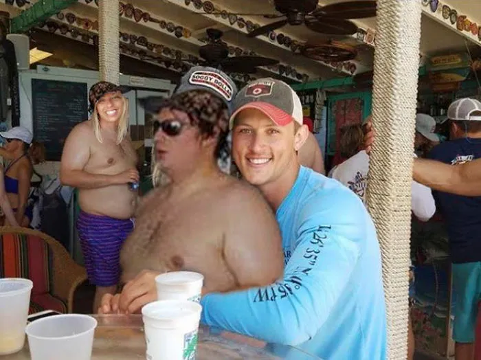 Couple Asks Internet To Photoshop Out Shirtless Guy From Engagement Photo, Regrets It Immediately