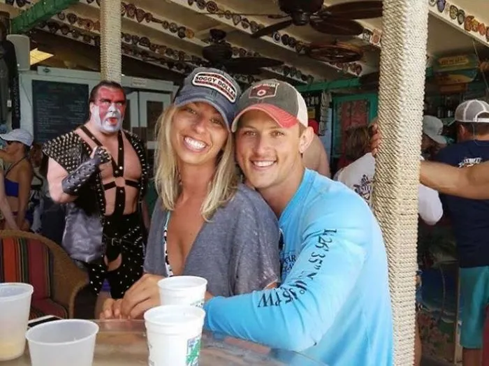 Couple Asks Internet To Photoshop Out Shirtless Guy From Engagement Photo, Regrets It Immediately