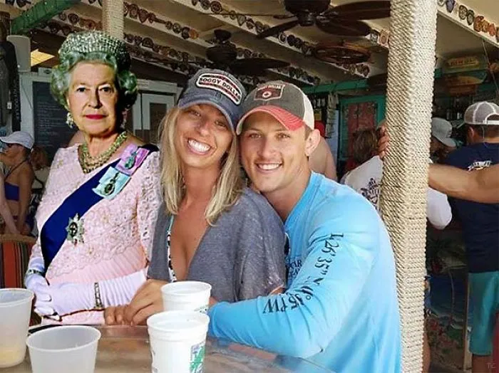 Couple Asks Internet To Photoshop Out Shirtless Guy From Engagement Photo, Regrets It Immediately