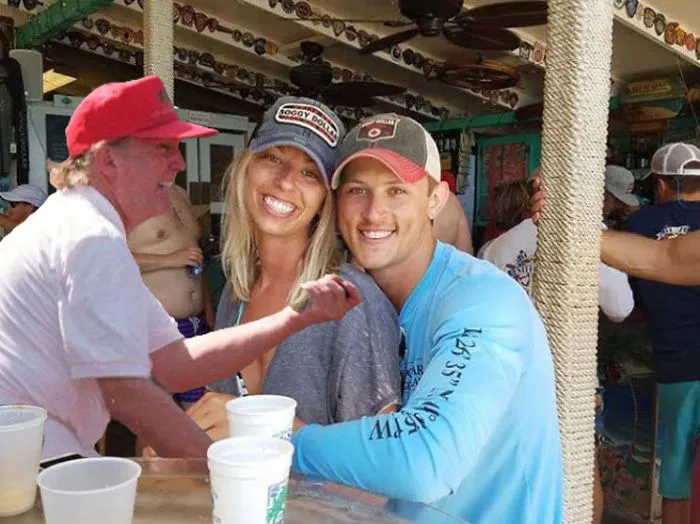 Couple Asks Internet To Photoshop Out Shirtless Guy From Engagement Photo, Regrets It Immediately