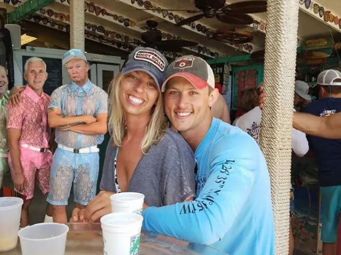 Couple Asks Internet To Photoshop Out Shirtless Guy From Engagement Photo, Regrets It Immediately