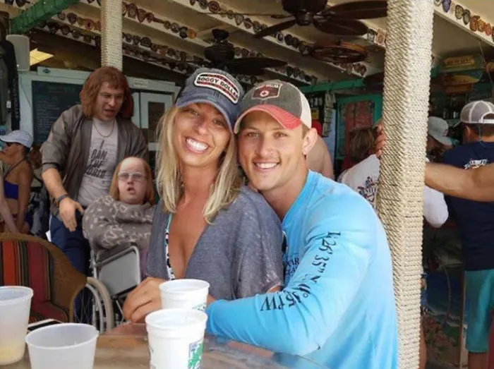 Couple Asks Internet To Photoshop Out Shirtless Guy From Engagement Photo, Regrets It Immediately