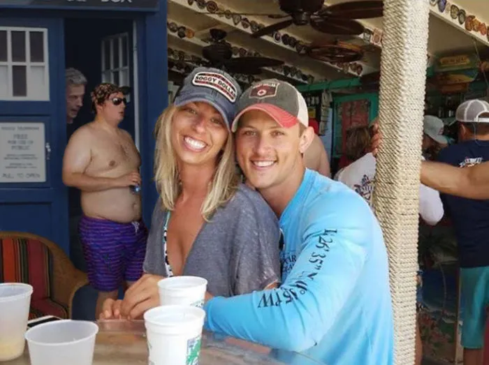 Couple Asks Internet To Photoshop Out Shirtless Guy From Engagement Photo, Regrets It Immediately