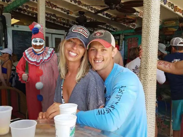 Couple Asks Internet To Photoshop Out Shirtless Guy From Engagement Photo, Regrets It Immediately