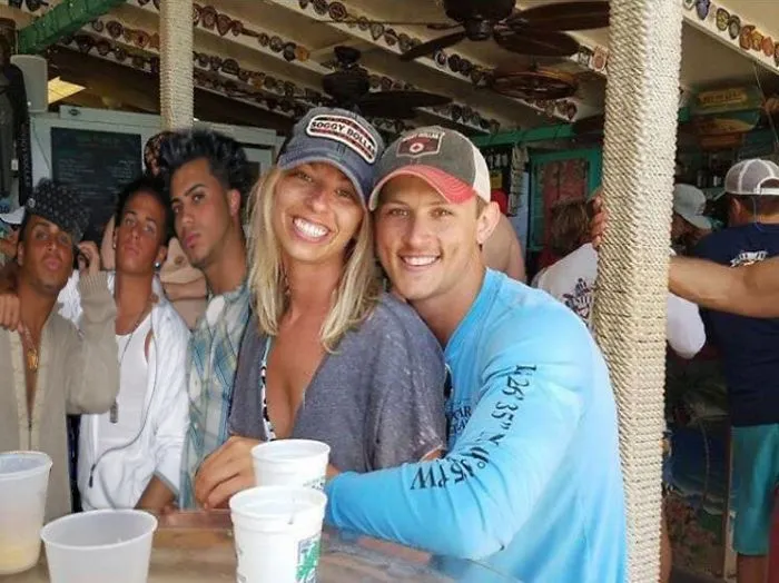 Couple Asks Internet To Photoshop Out Shirtless Guy From Engagement Photo, Regrets It Immediately