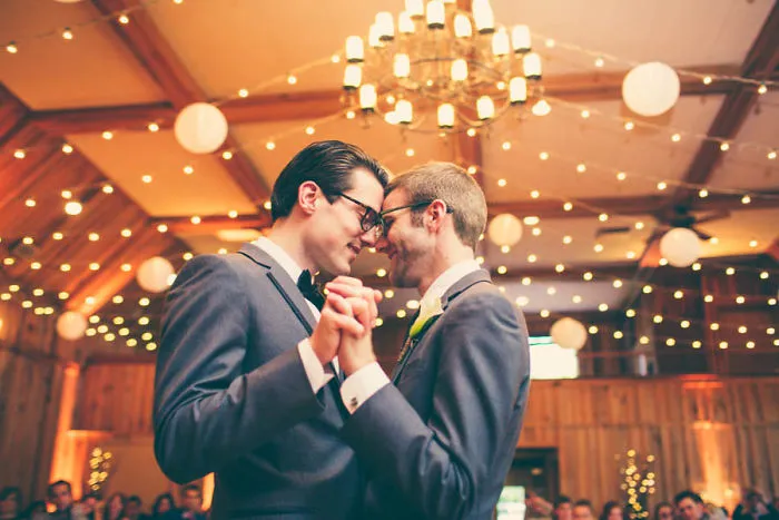 Two happy men holding hands and dancing 