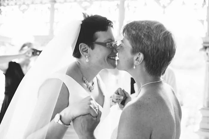 Two women holding hands and kissing 