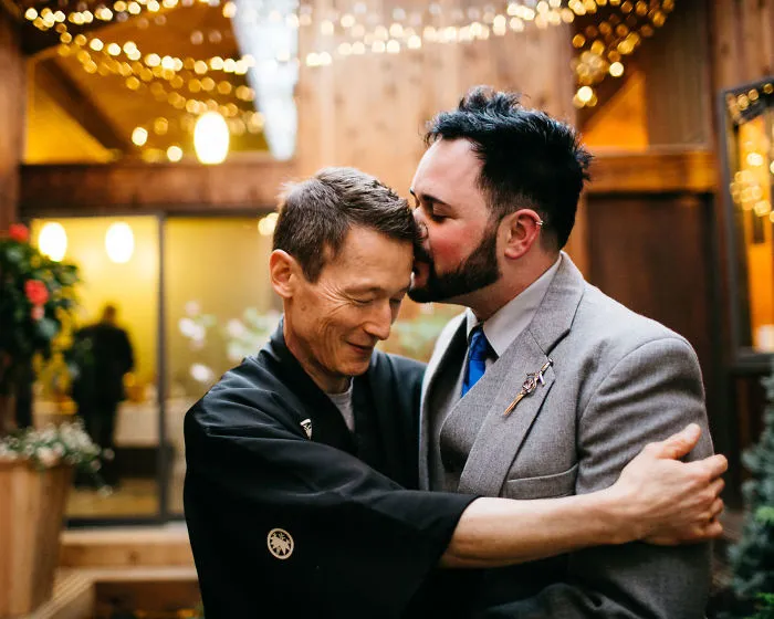 Two men kissing and hugging 