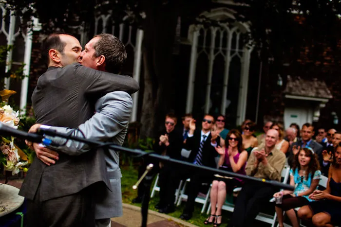 Two men kissing on stage 