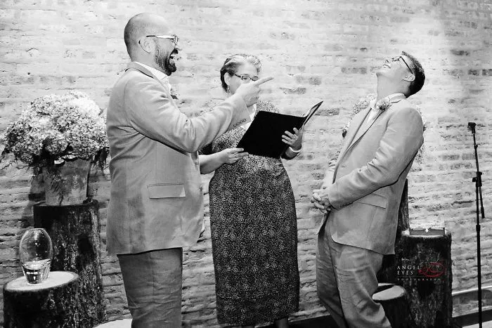 Two men laughing near a pastor 