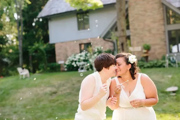 Two happy women kissing 
