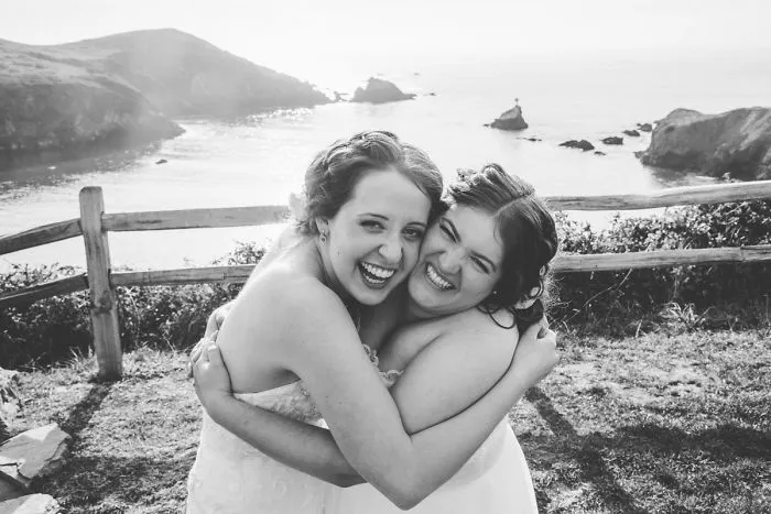 Two women hugging and laughing 