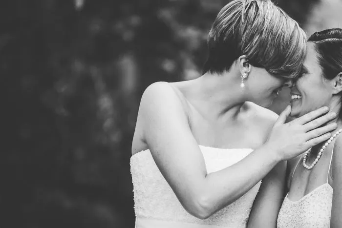 Two happy women kissing 