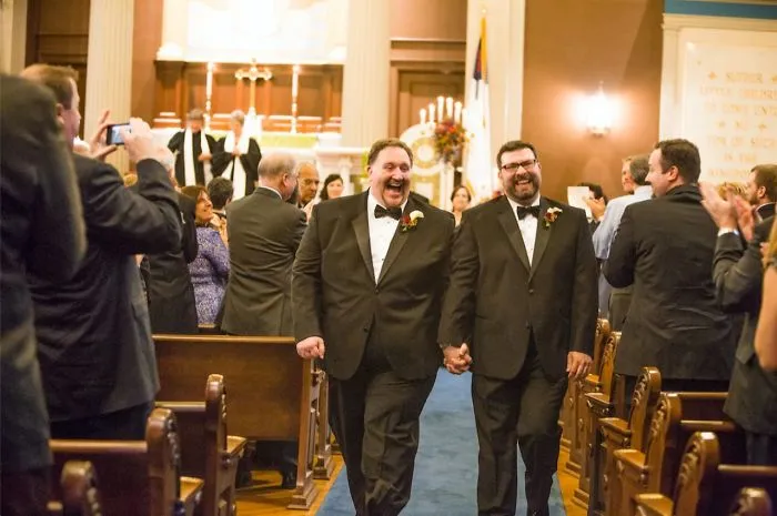 Two man holding hands and walking 
