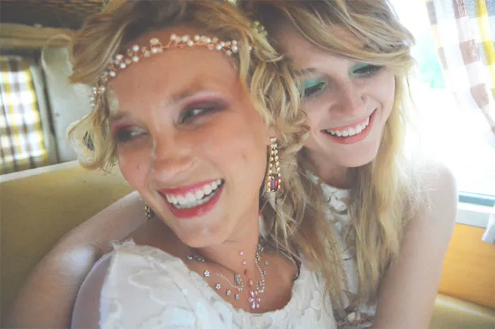 Two happy women hugging in car 