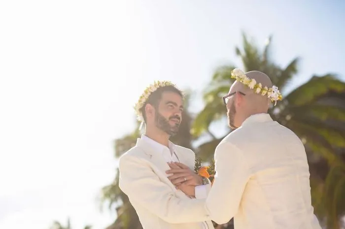 Two men holding hands 