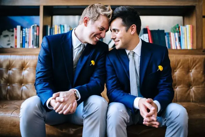 Two men sitting and looking each other into eyes 