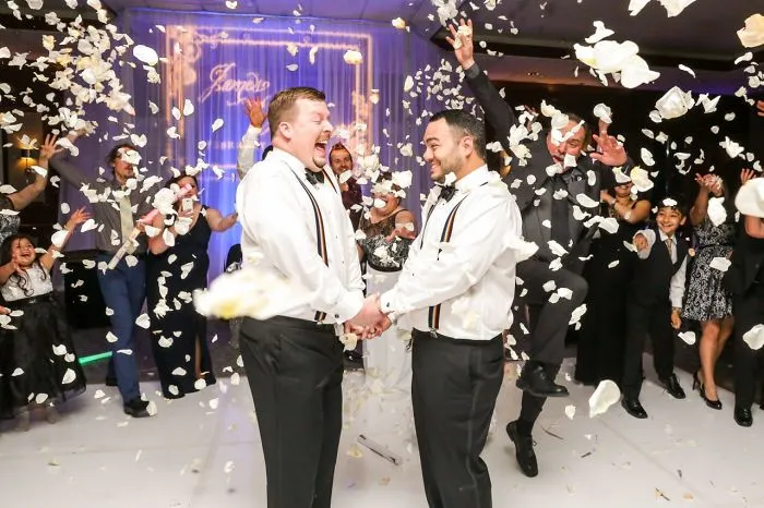 Two men dancing and holding hands 