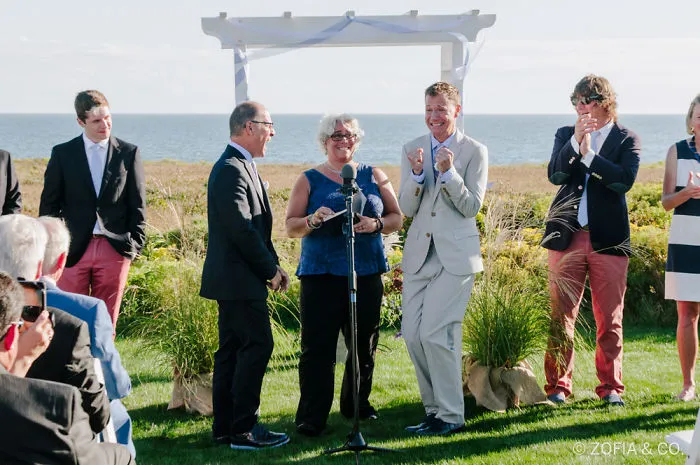 Multiple happy people on a lawn in the middle of the wedding 