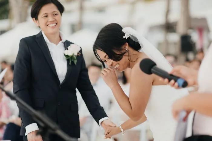 Two women holding hands and laughing 