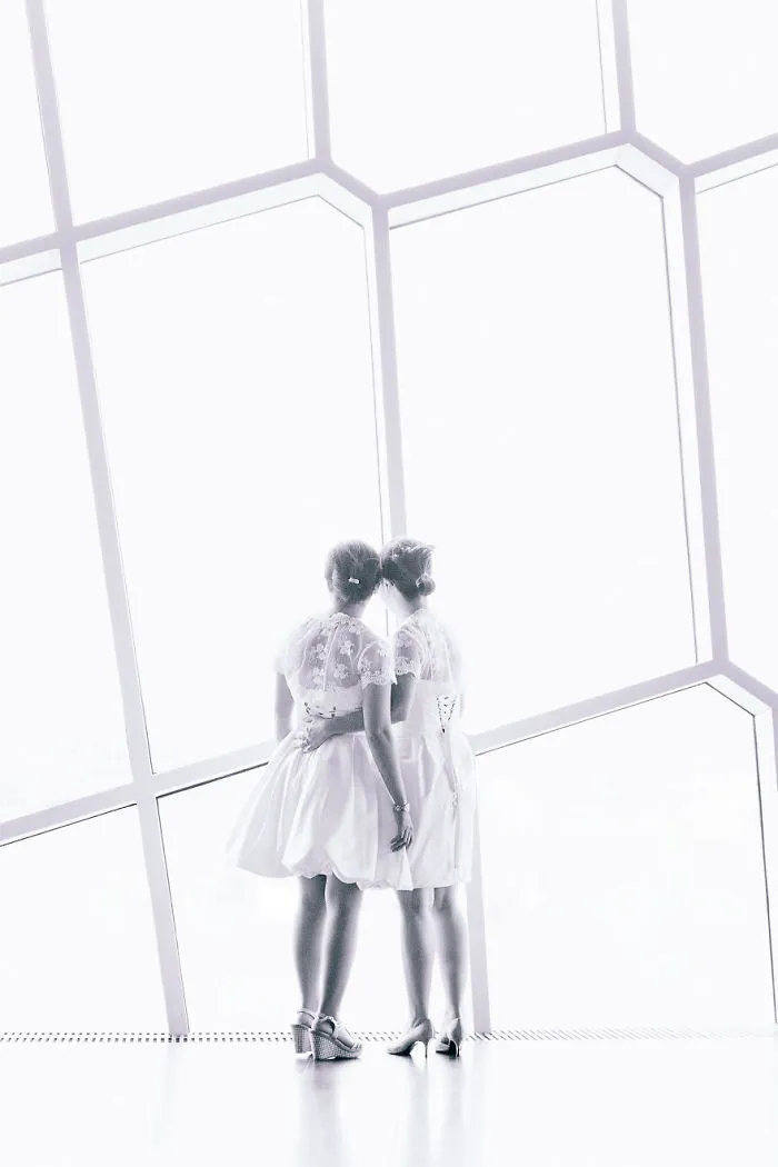 Two woman hugging and looking through the window 