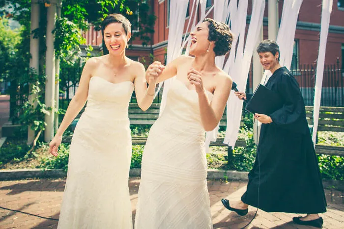 Two happy women holding hands 