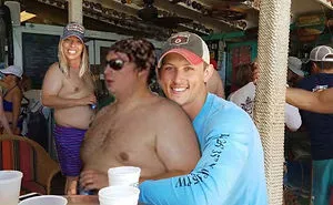Couple Asks Internet To Photoshop Out Shirtless Guy From Engagement Photo, Regrets It Immediately