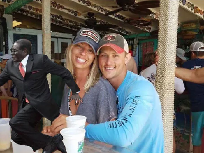 Couple Asks Internet To Photoshop Out Shirtless Guy From Engagement Photo, Regrets It Immediately