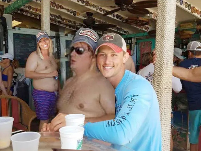 Couple Asks Internet To Photoshop Out Shirtless Guy From Engagement Photo, Regrets It Immediately