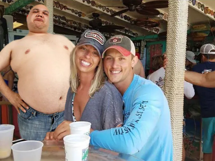 Couple Asks Internet To Photoshop Out Shirtless Guy From Engagement Photo, Regrets It Immediately