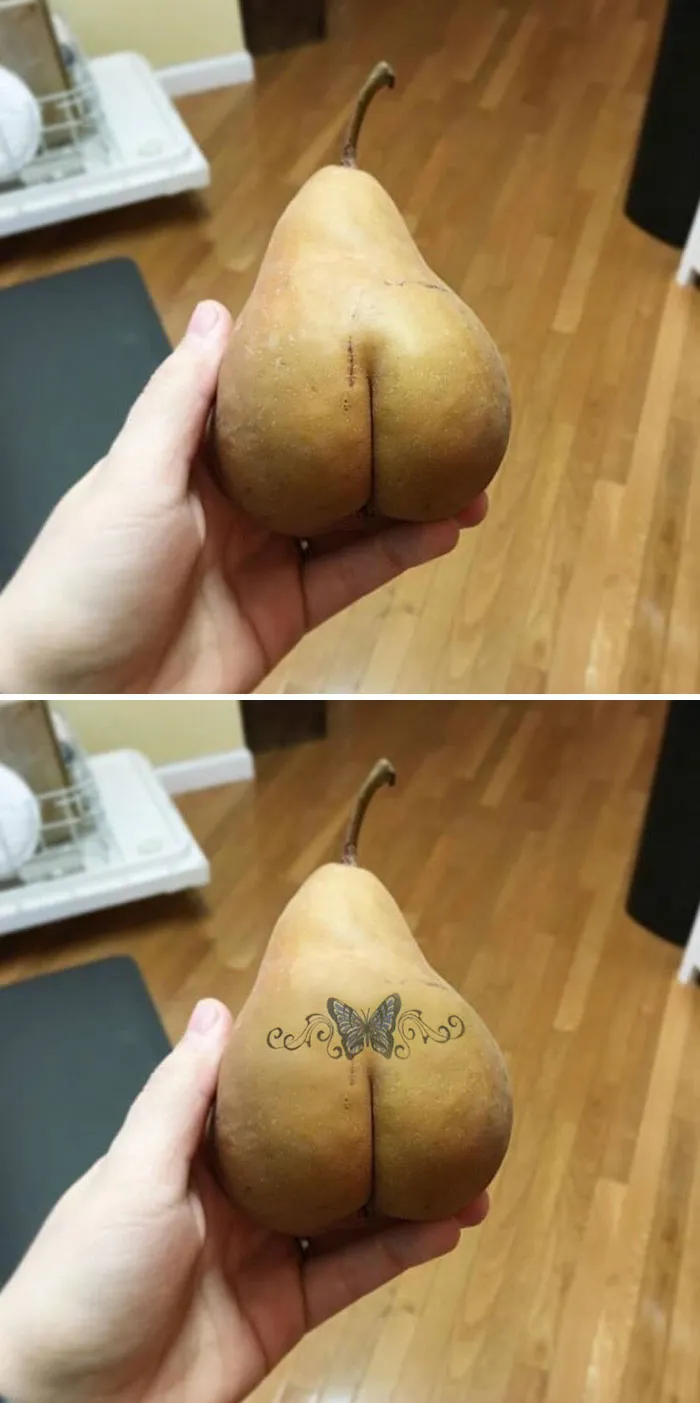 Hand holding a pear, Photoshopped with a butterfly tattoo on its surface.