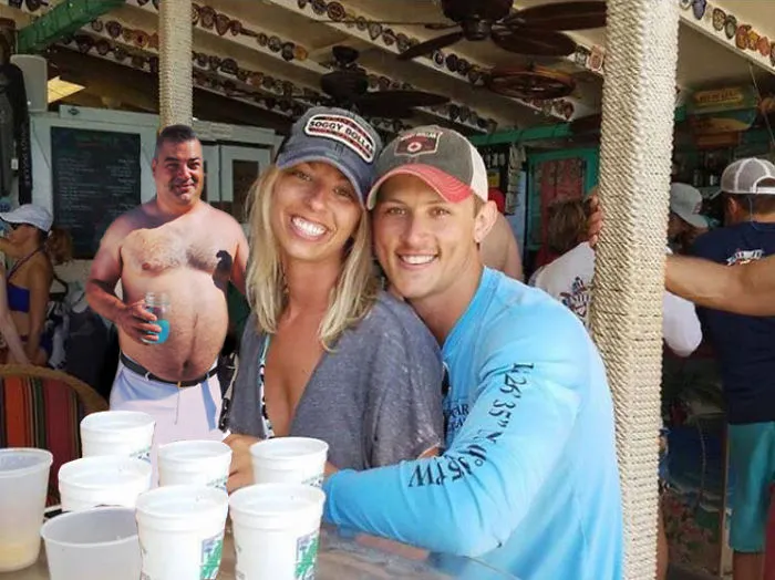 Couple Asks Internet To Photoshop Out Shirtless Guy From Engagement Photo, Regrets It Immediately