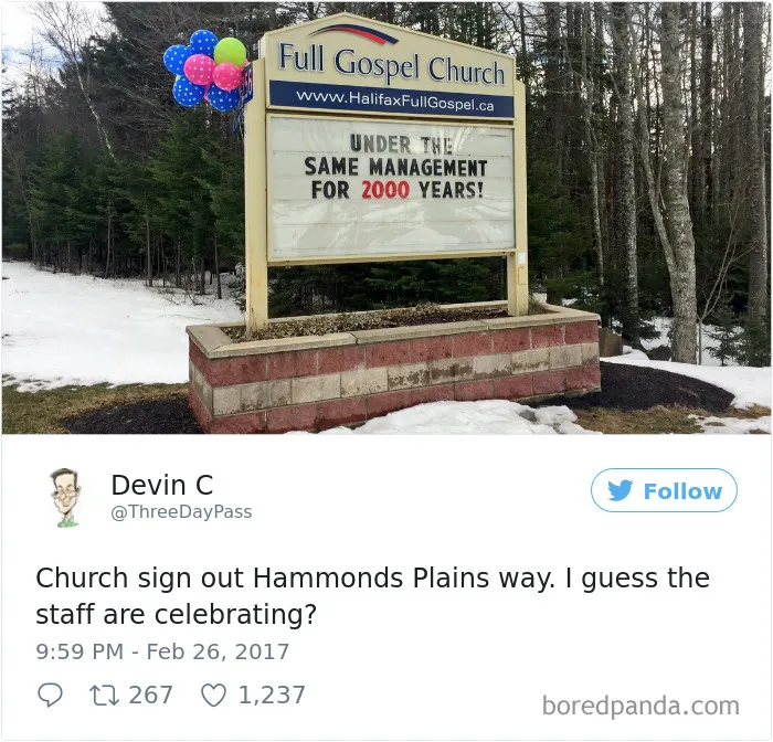 Funny church sign reading "Under the same management for 2000 years" with colorful balloons next to it.