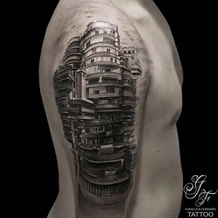Architectural tattoo of a detailed building design on a person's upper arm.