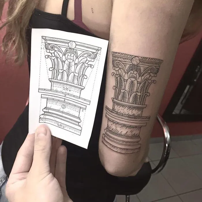 A detailed architectural tattoo of a Corinthian column design on a woman's arm beside its sketch.
