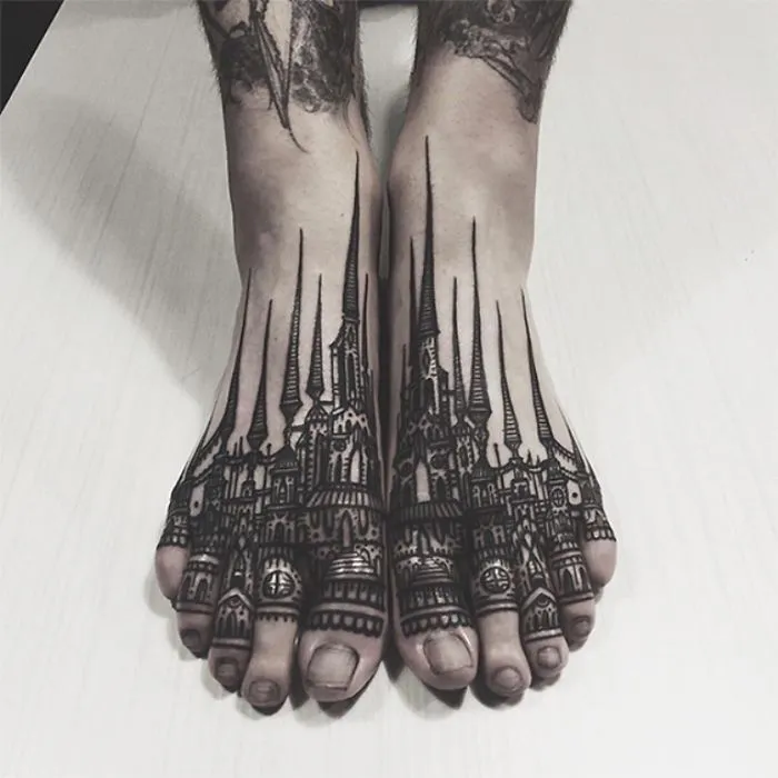 Intricate architecture tattoo design on feet with detailed spires and arches.