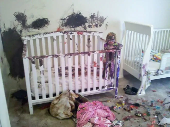A crib covered in colorful paint after kids are left alone, showcasing a hilarious mess.