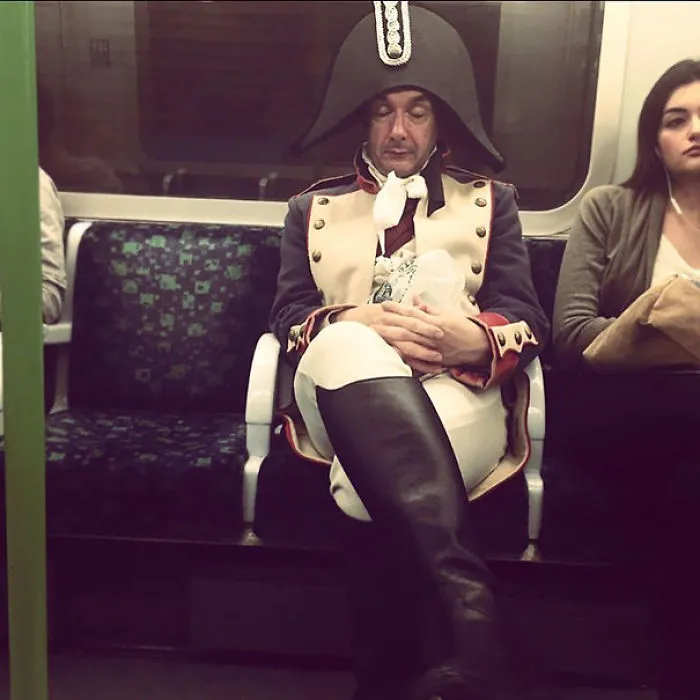 Man dressed as Napoleon sleeping on the subway, exemplifying weirdest people spotted on public transport.