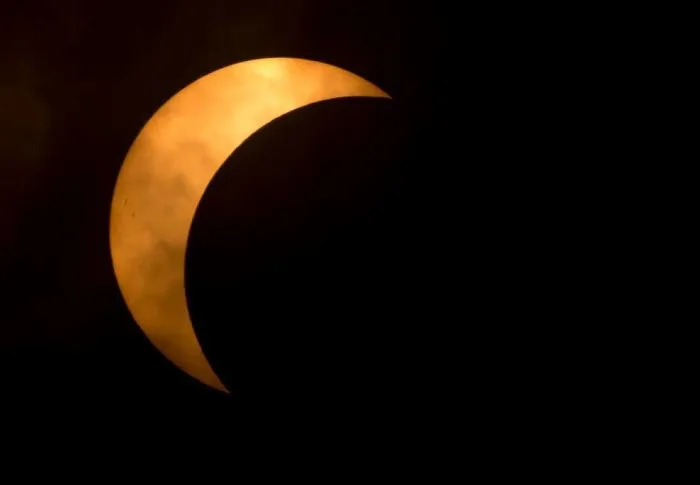 Close Obscure The Moon As It Covers A Part Of The Sun During A Partial Eclipse In Richmond, Va
