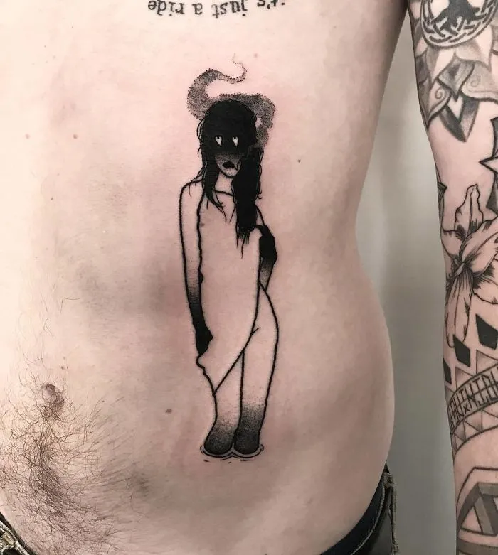 Tattoo of a faceless girl on a person's side, incorporating dark and abstract elements.