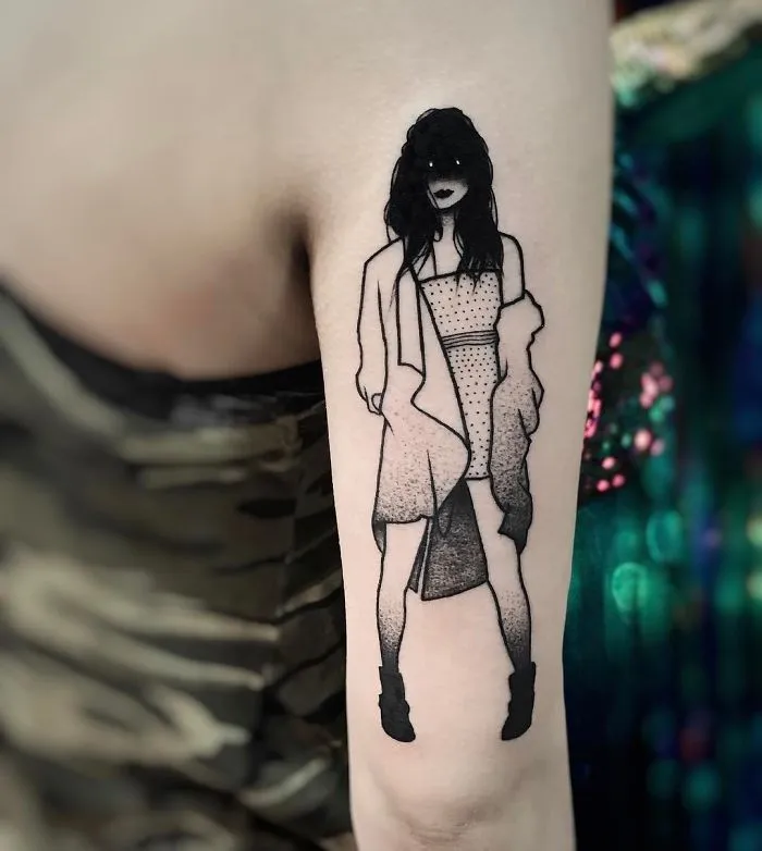 Tattoo of a faceless girl in a stylish outfit on an arm, blending subtle eroticism with artful detail.