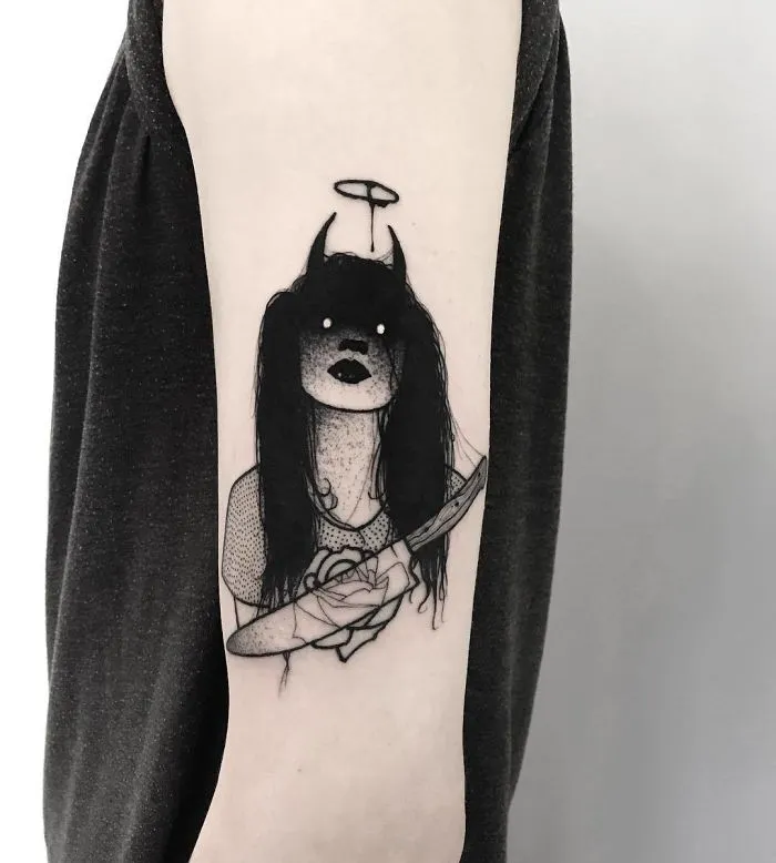Tattoo of a faceless girl with dark hair and a halo, holding a rose and knife on an arm.