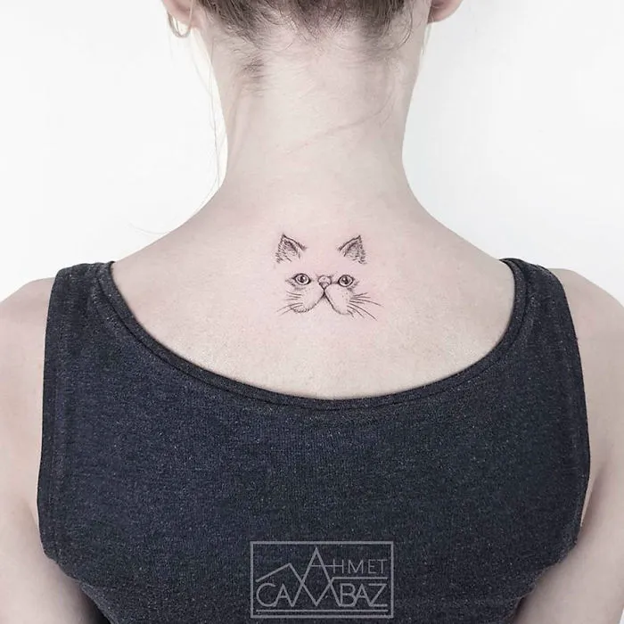 Minimalist cat tattoo design on a person's neck, created by a former Turkish cartoonist.